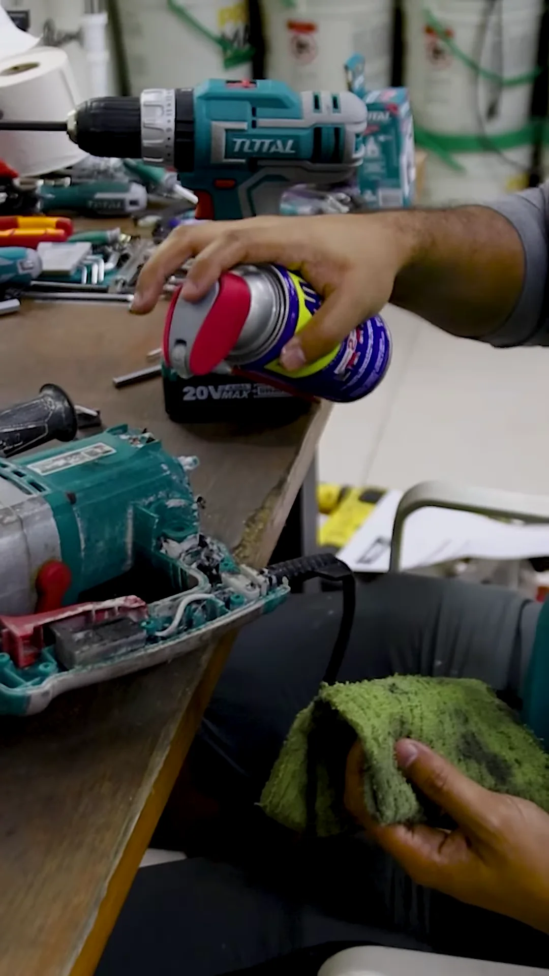A technician servicing an opened power tool at the Kallisto Total Store repair bench